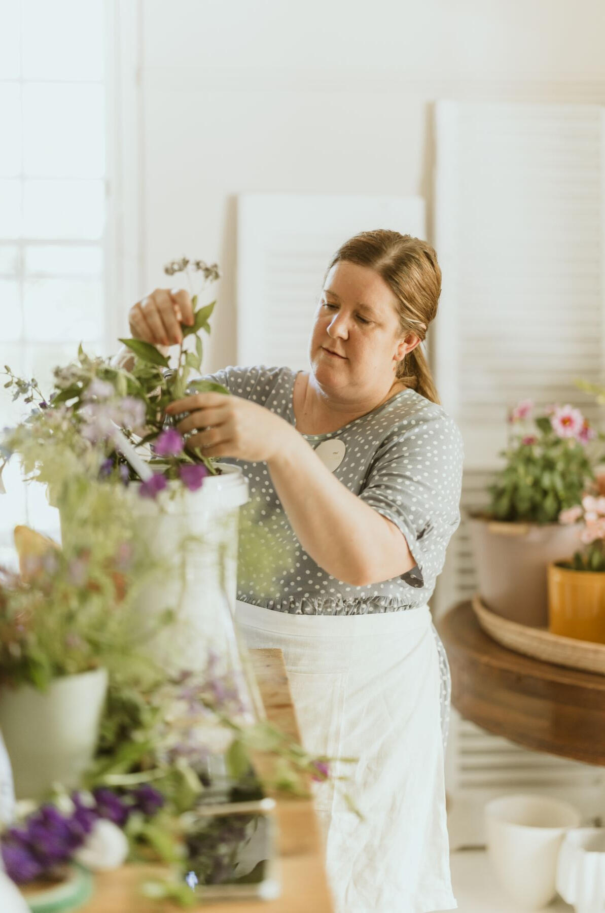 Whimsy Botanical Collective Founder Leigh creating a floral design